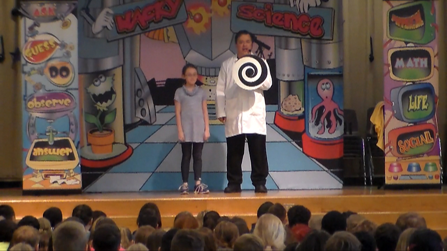 STEM science school assembly performer Cris Johnson with a child