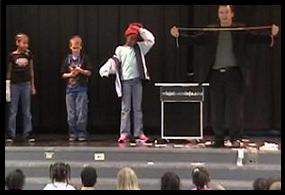 School Assembly Presenter Cris Johnson performing with 3 volunteers